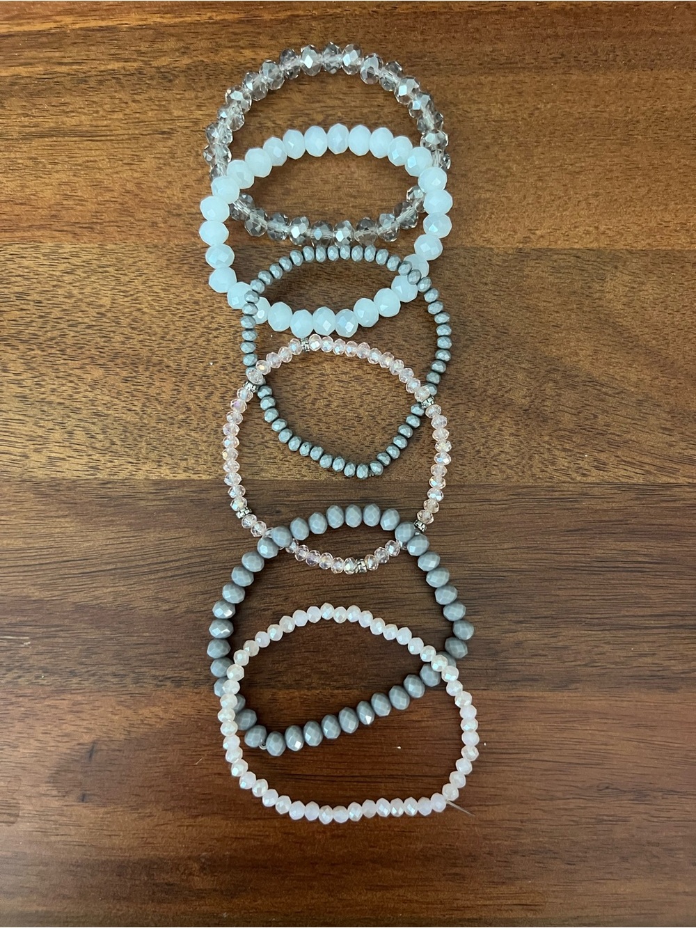 Stack of Women's Beaded Stretch Bracelets in White, Gray and Pink